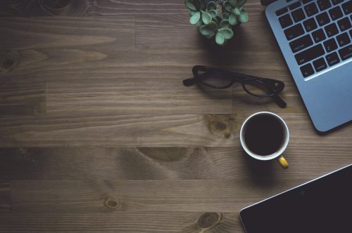 a cup of coffee on a rustic wooden table