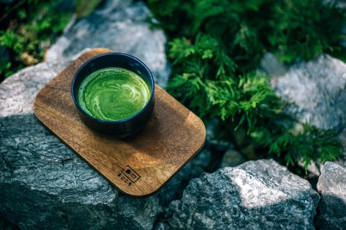 matcha-tea-on-wooden-board-in-nature