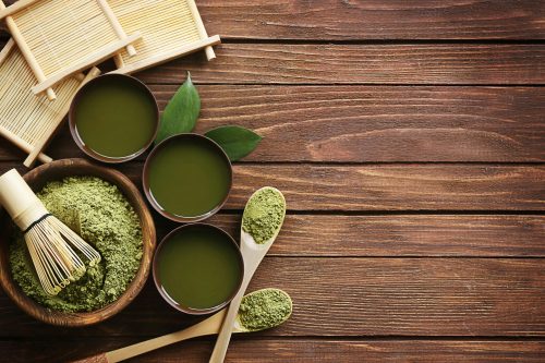 matcha-powder-and-matcha-tea-matcha-spoons-on-wooden-table